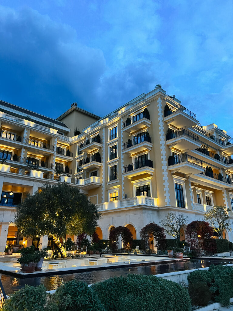 illuminated-facade-hotel-with-garden-courtyard-against-dark-sky